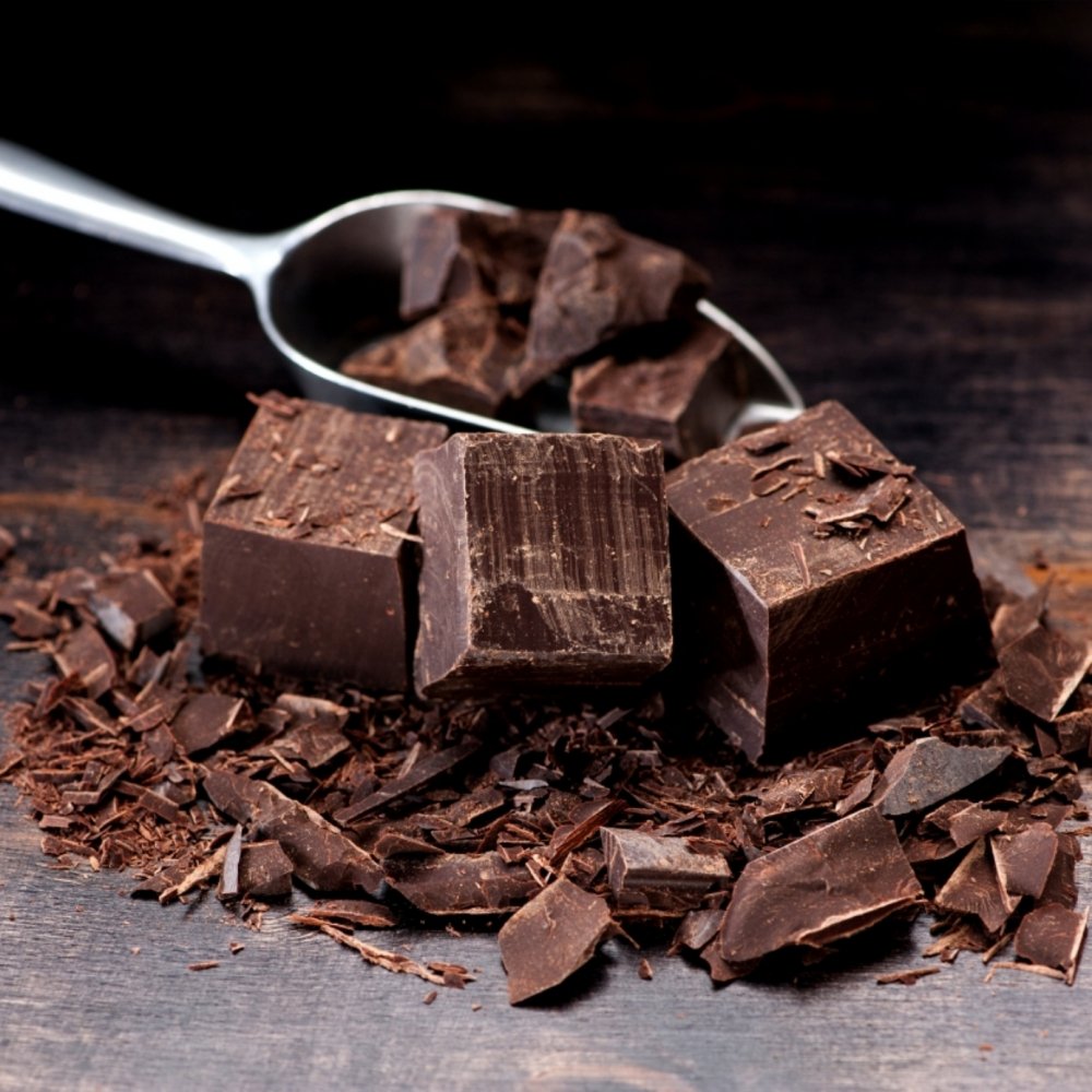 Ceremonial cacao blocks and shavings with a metal scoop – bulk quantity visual